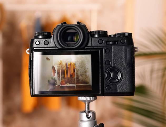 Taking photo of stylish clothes indoors, focus on camera